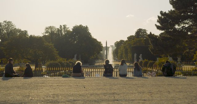 People talking near Louvre Fountain in Paris 