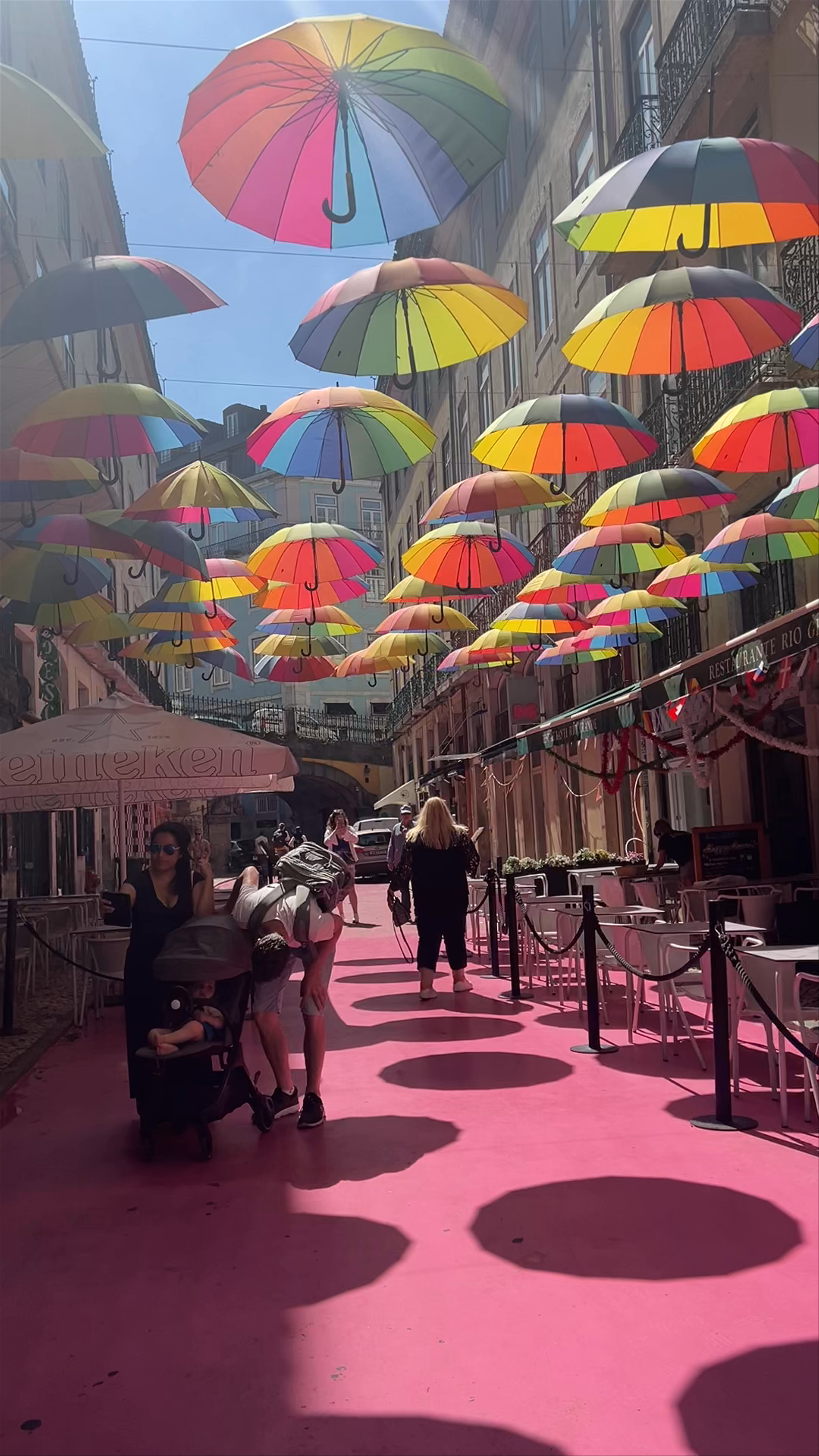 Pink Street Magic: Rainbow Umbrellas Over Lisboa's Vibrant Alley