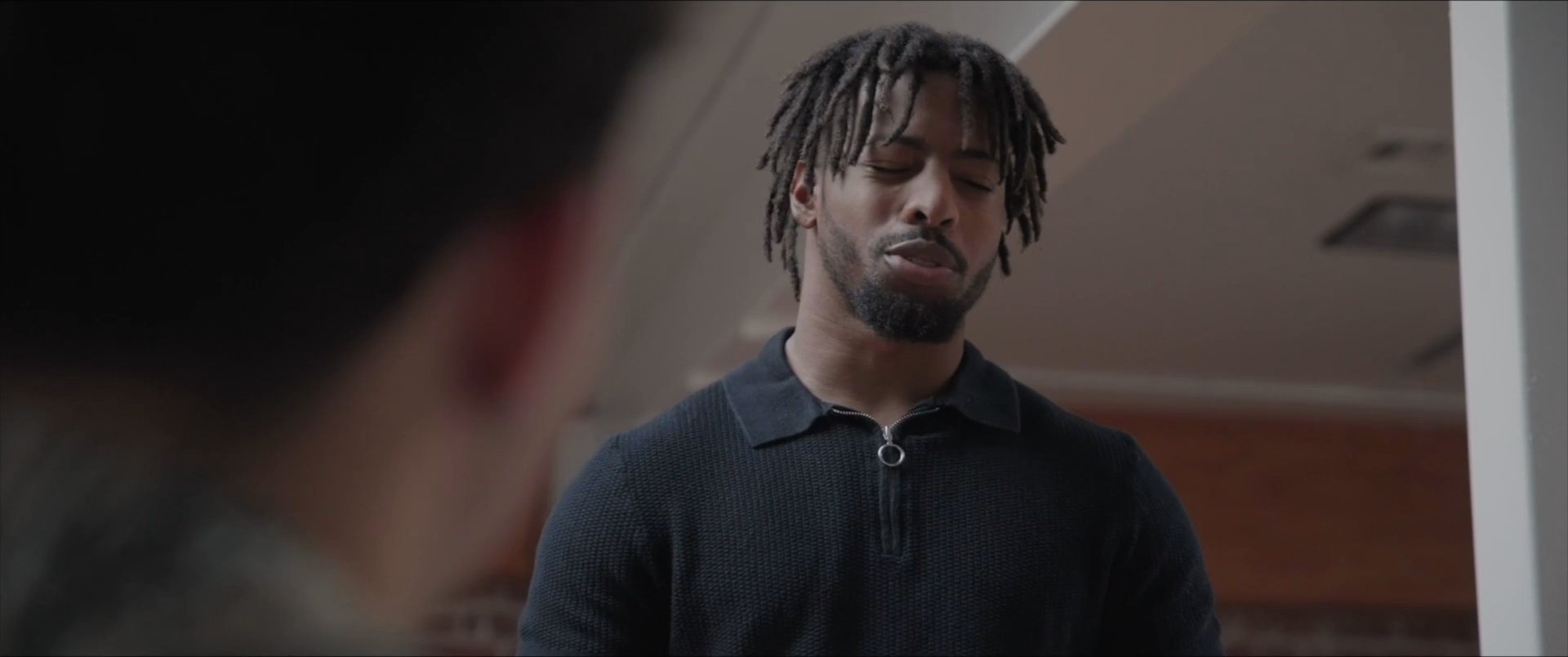 Two individuals engage in a focused, face-to-face dialogue within a professional setting. The sequence captures their attentive reactions and reciprocal communication.