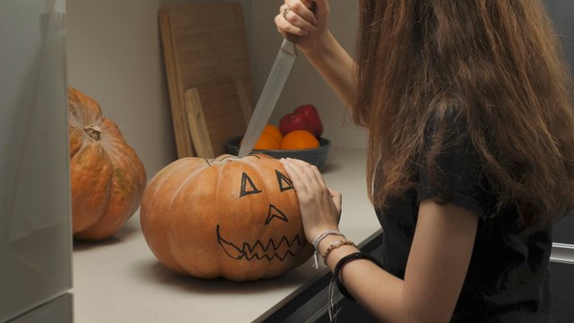 Girl carving a pumpkin
