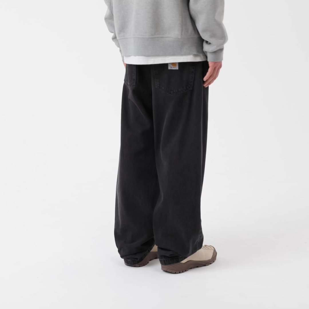 Model wearing a pair of Landon Pants in Black Stone Washed
