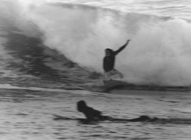 This presentation introduces the personal combat memoir Surfing to Saigon, transitioning from book cover imagery to archival footage of surfers and historical photographs of veterans.