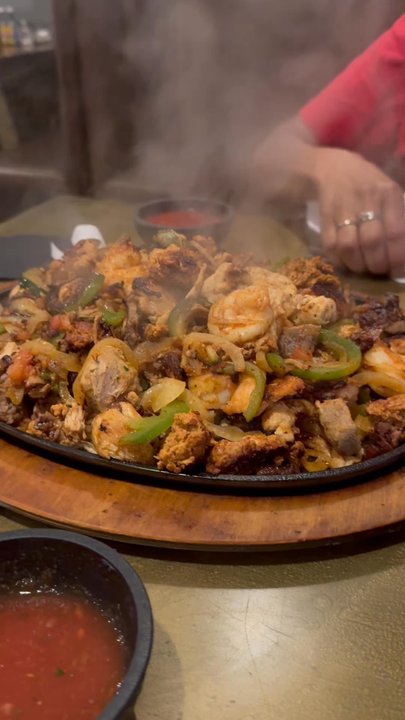 El Potrero - These are the fajitas for two.  It has chicken, beef and shrimp.  Plus each person gets their own plate of sides and tortillas. - Mexican Near Me - Flint, Michigan