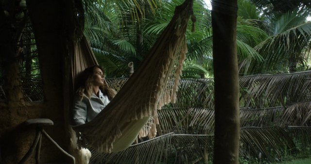 Woman lying in a hammock