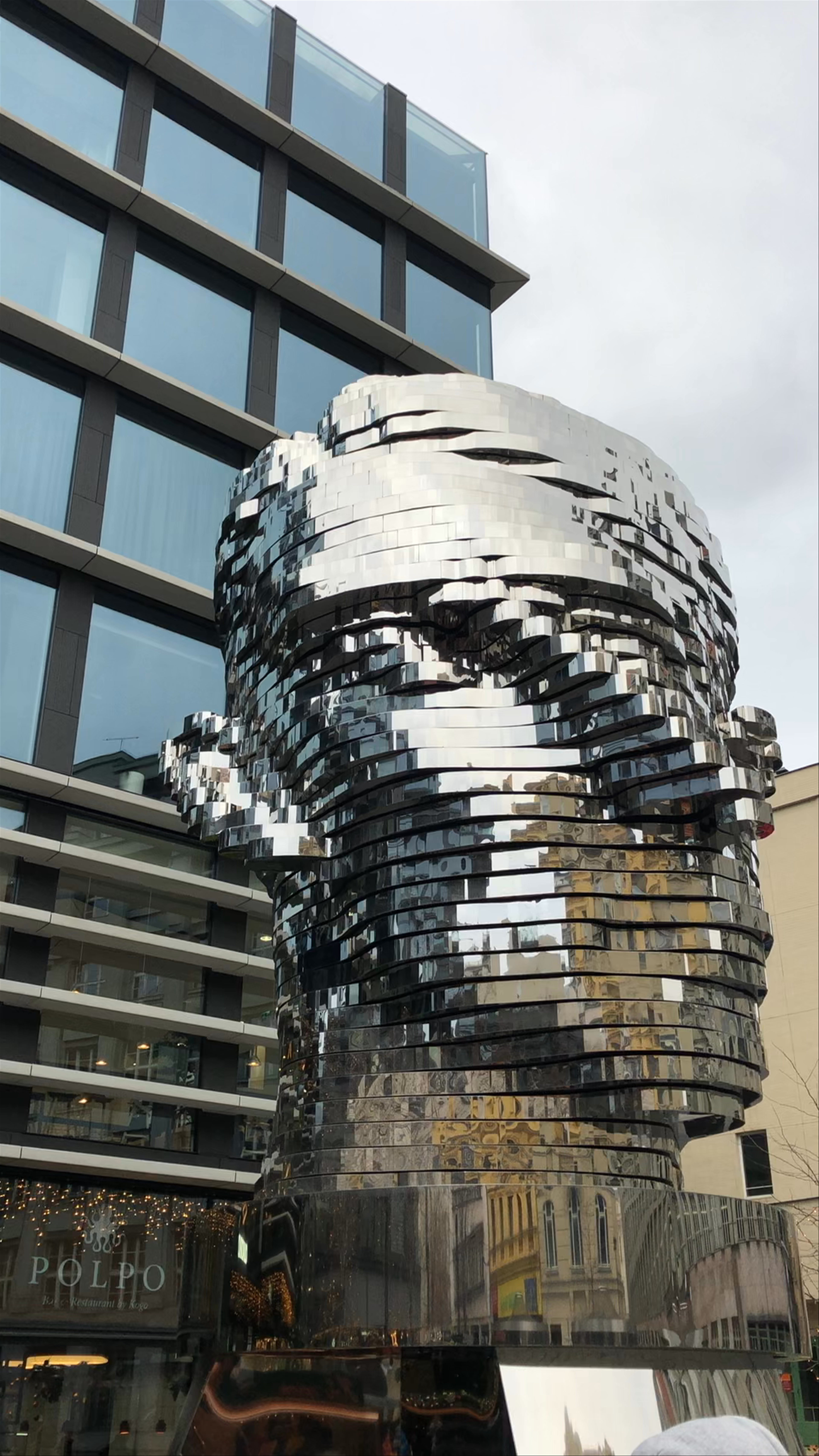 Rotating Kafka Head Sculpture in Prague's New Town