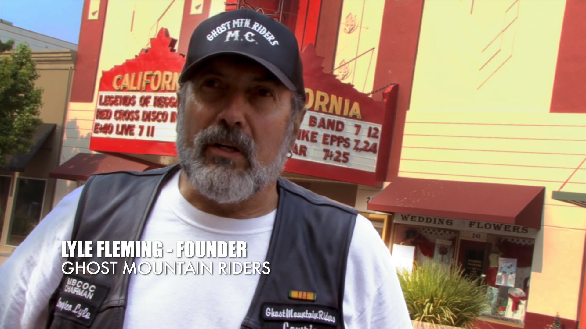 Lyle Fleming, founder of the Ghost Mountain Riders motorcycle club, discusses the organization's history and community presence in an outdoor setting.