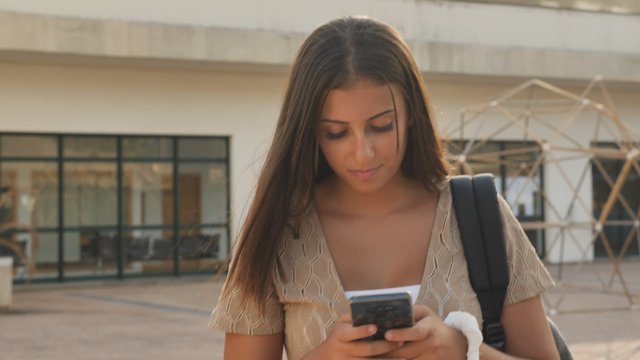 Student checking social media on school campus