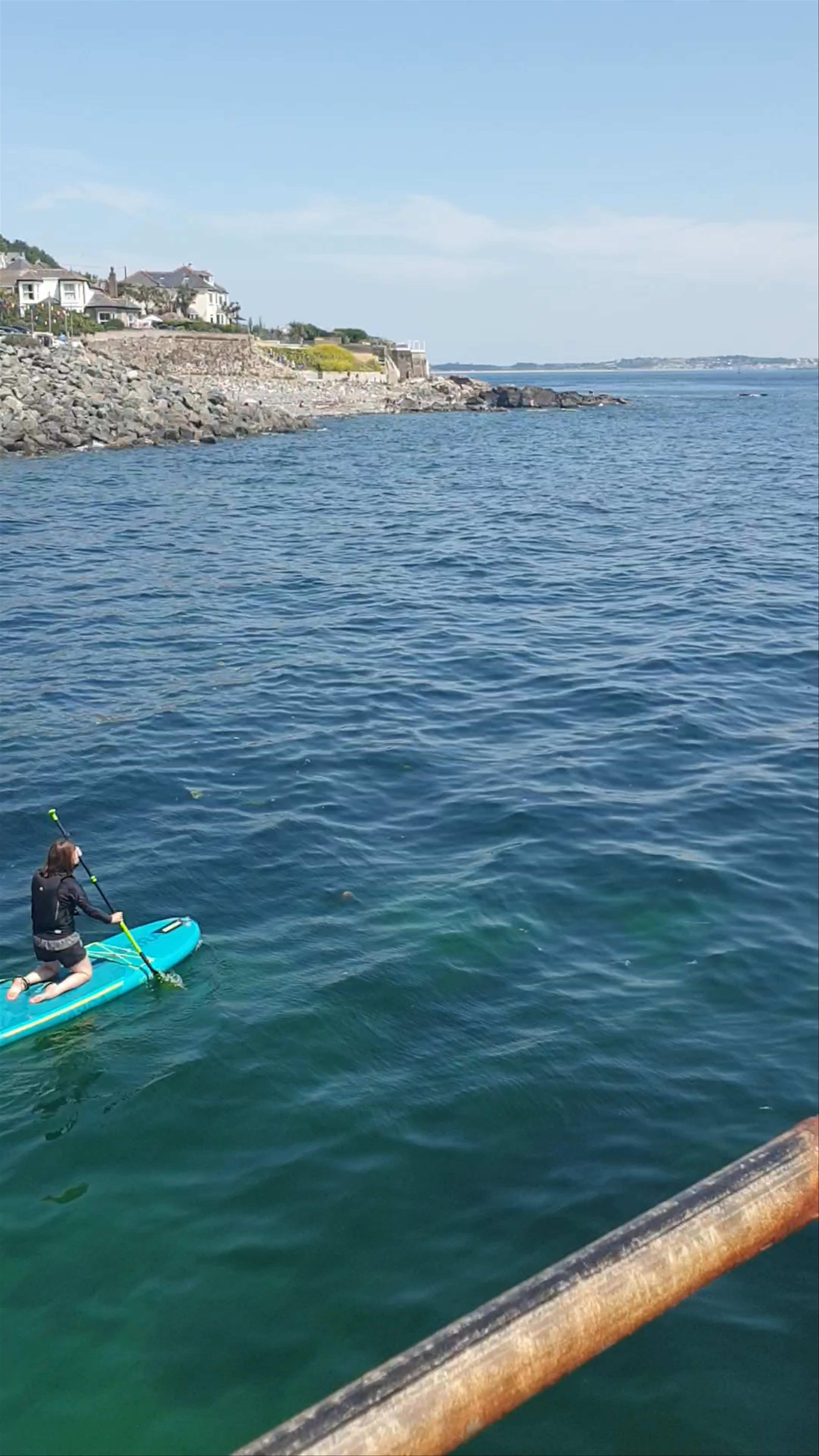 Sunlit Paddleboarding and Coastal Charm at Mousehole Harbour, Cornwall