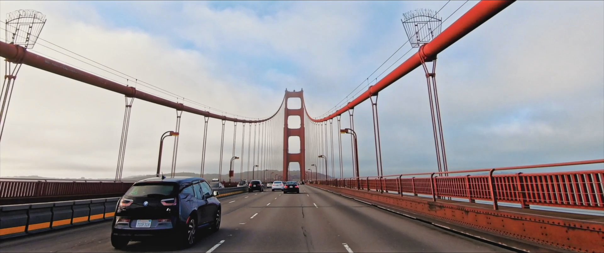 A traveler packs for a trip before driving through the San Francisco landscape, passing landmarks including the Golden Gate Bridge and iconic city streets.