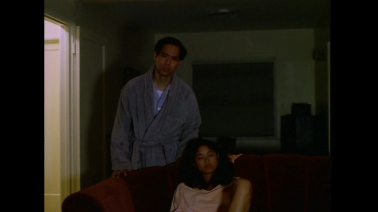 A man discovers a woman watching television late at night and attempts to enforce bedtime, leading to an argumentative exchange.