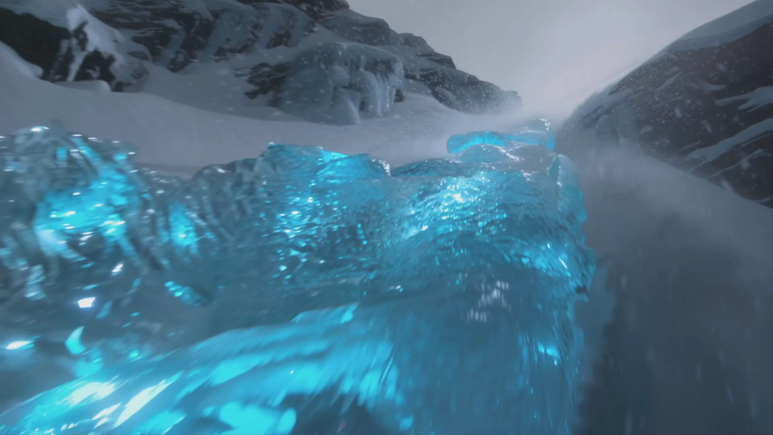 A low-angle, wide-screen 1920x1080 video frame showing a bright, glowing blue stream of crystalline ice flowing through a snowy mountain pass. The scene, generated by Kling 2.6 Pro, features snow-covered rocky slopes on either side under a hazy, overcast sky.