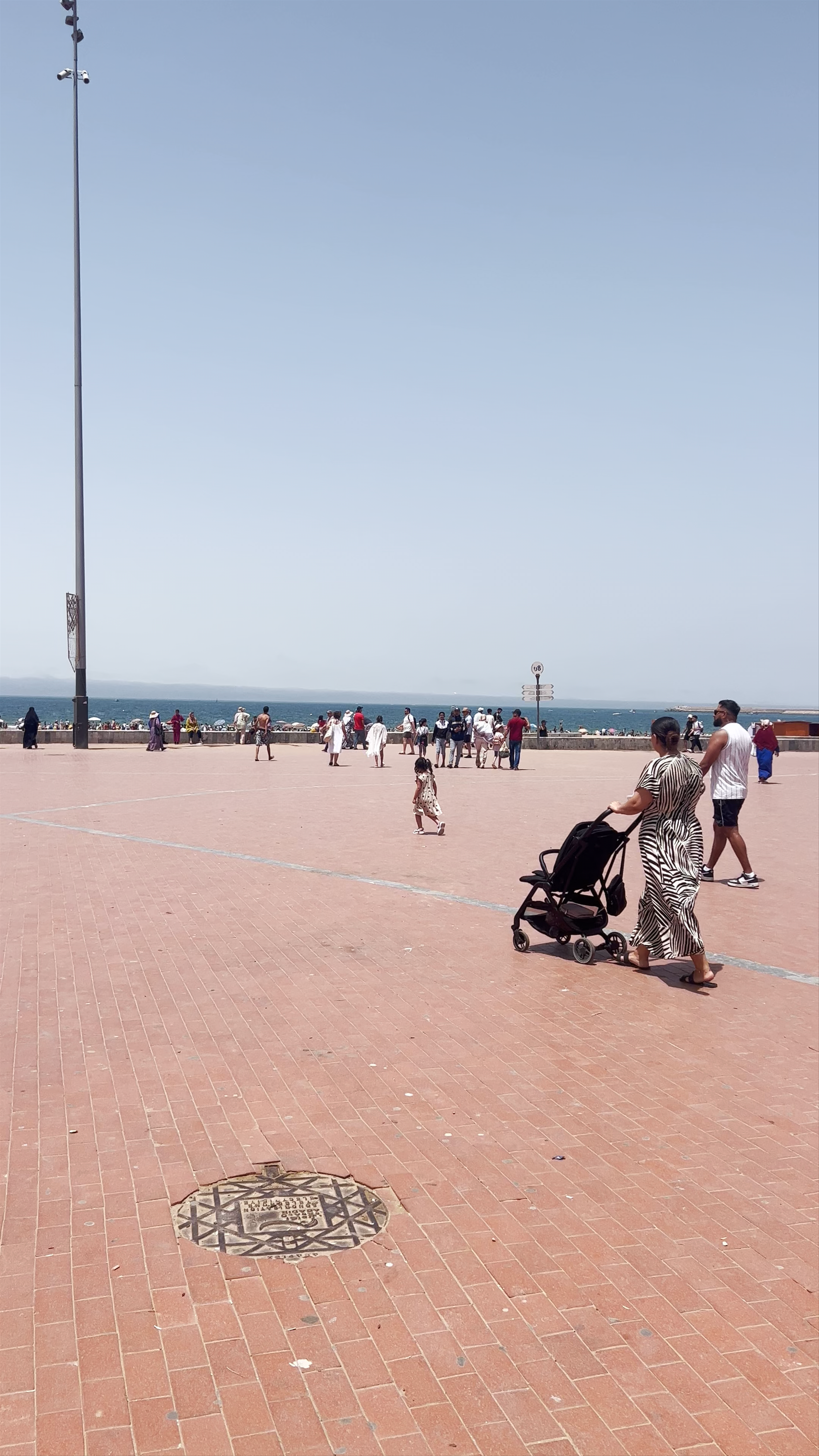 Corniche Agadir: Vibrant Coastal Life Under Clear Blue Skies