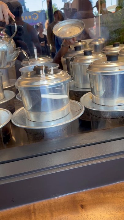 Saigon Coffee - Pouring hot water into the phin filters. This is the Largest phins I have ever seen! - Vietnamese Near Me - San Diego, California