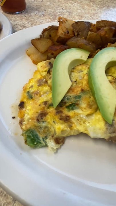 Tin Can Cafe - TEX MEX Omelette  Steak, chorizo, peppers, onion, & cheese. Topped with avocado slices. Side of home fries potatoes & white toast - Cafes Near Me - Clearwater, Florida