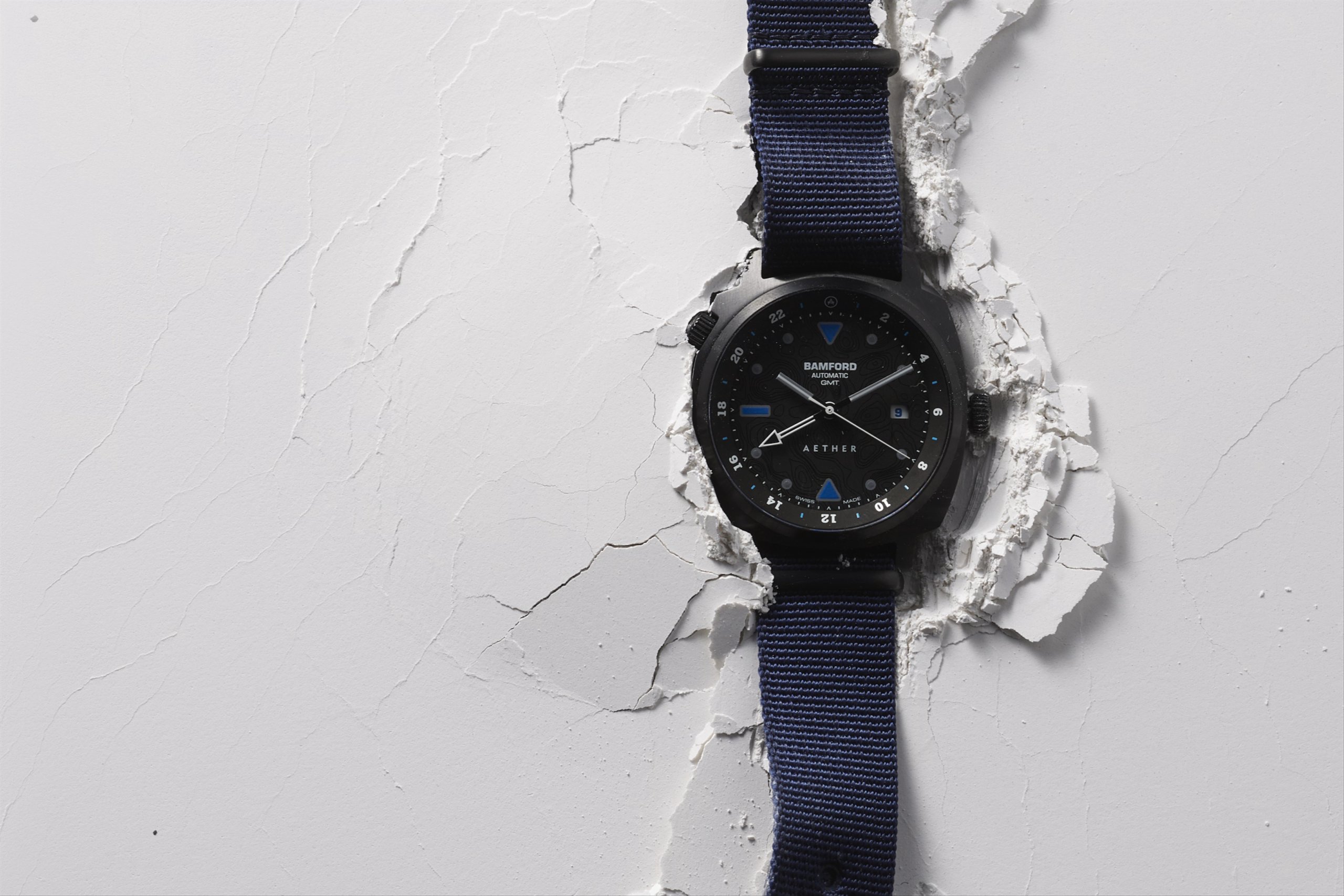 Video of Bamford watch sitting on cracked white surface with seconds hand looping