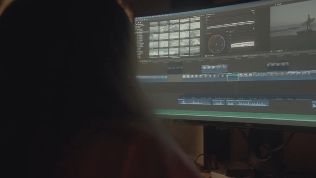 A woman editing videos on a computer