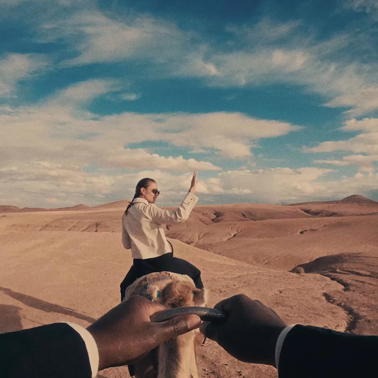 POV video of a man riding on a camel with a woman ahead riding as well