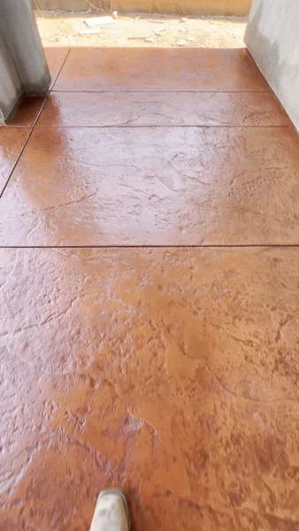 Stamped concrete porch with a natural slate texture in warm terracotta color