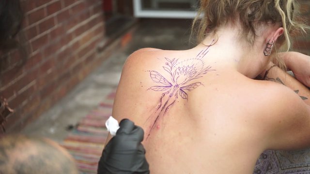 Tattoo artist working 