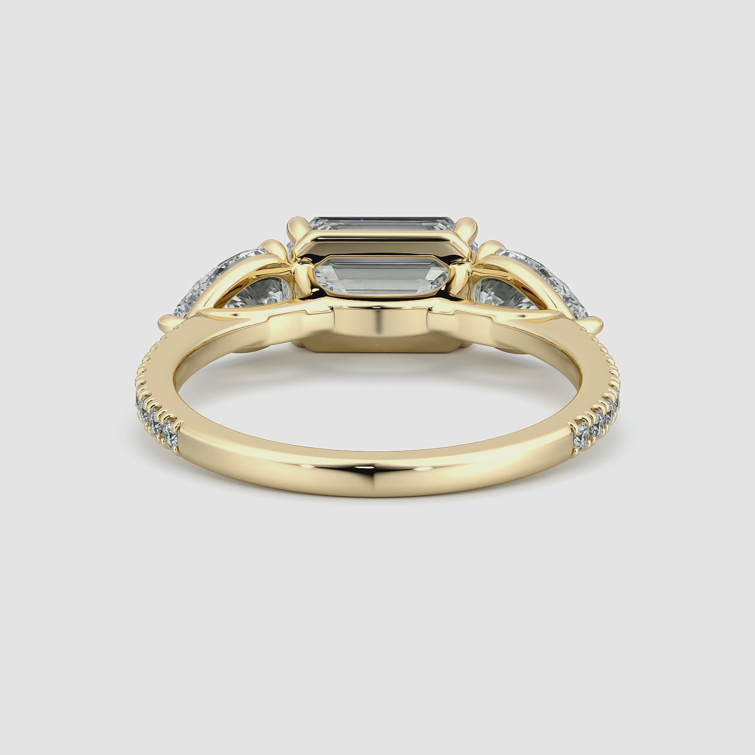 The Three Stone | Emerald | 18k | Yellow Gold | bandAccent: Pavé | diamondOrientation: horizontal | sideStoneCarat: 0.50ct | sideStoneShape: Pear | caratWeight: other