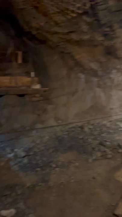 Sierra Silver Mine Tour - Using the muck shovel. - Tours Near Me - Wallace, Idaho