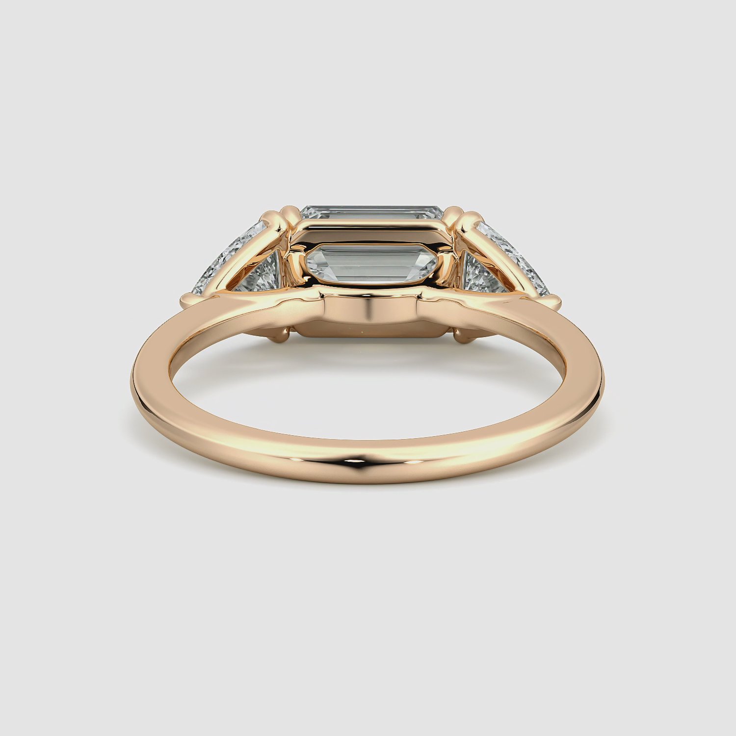 The Three Stone | Emerald | 14k | Rose Gold | bandAccent: Plain | diamondOrientation: horizontal | sideStoneCarat: 0.50ct | sideStoneShape: Trillion | caratWeight: other
