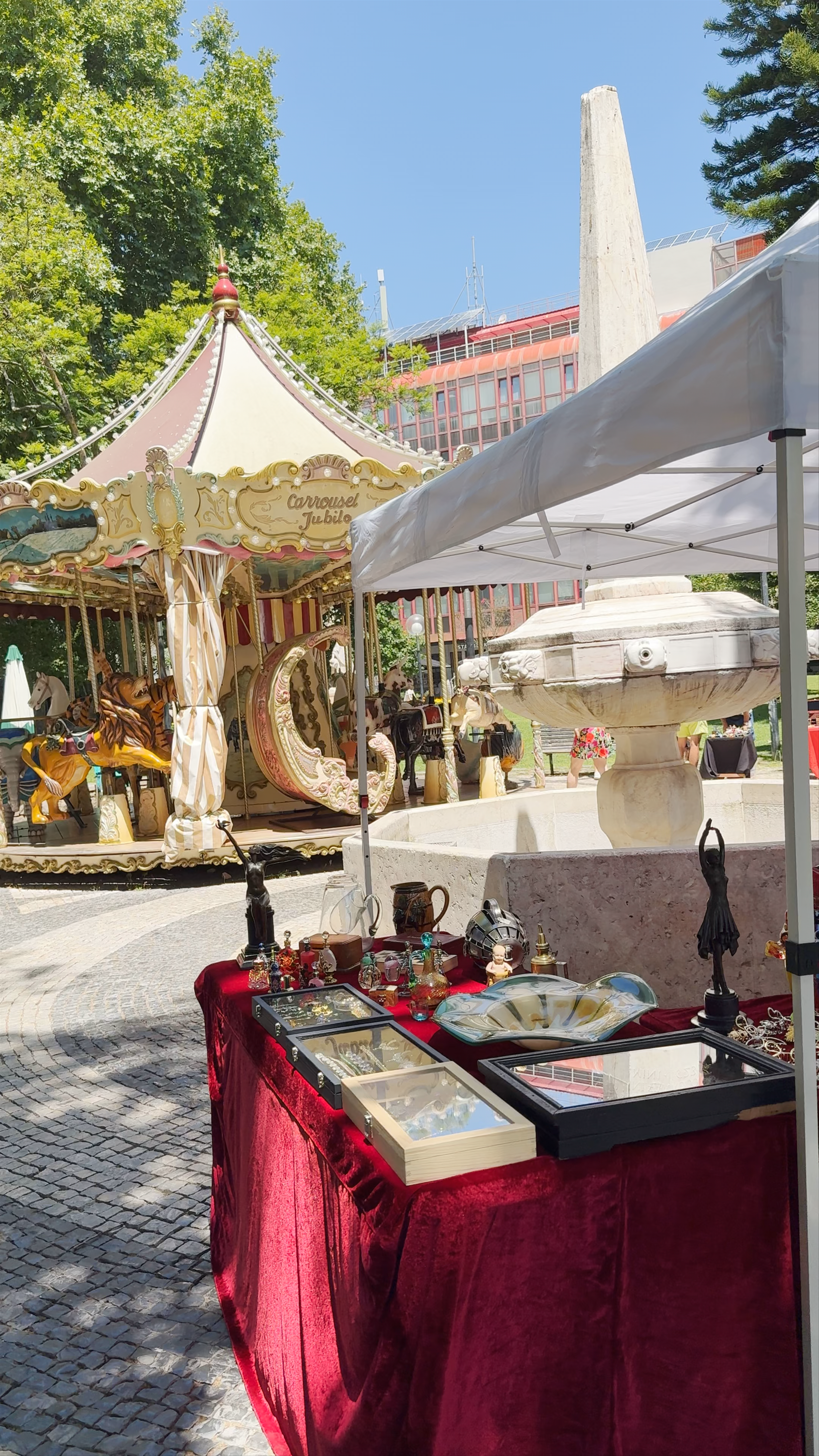 Sunlit Artisan Market & Vintage Carousel at Jardim Visconde da Luz, Cascais