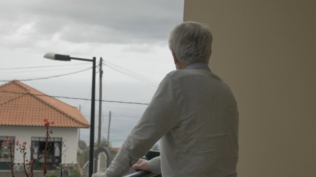 Old man waving to his neighbor