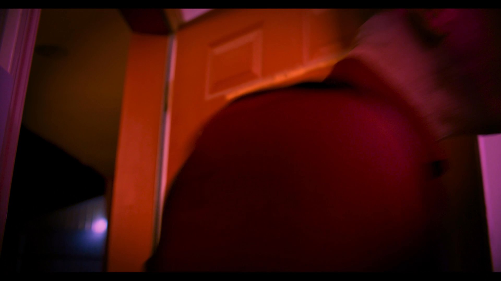 Two men engage in a tense and aggressive verbal exchange within an interior setting, displaying visible signs of conflict and frustration.