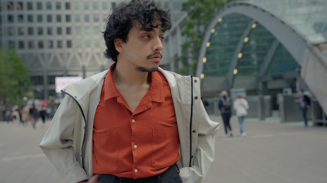 A young man posing on the street in the city