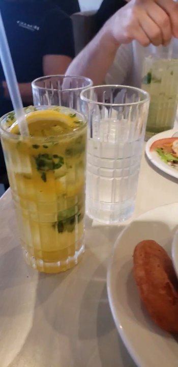 Tozton - My partner's mojito even in this video looks bad. He was really trying to break the mint leaves for more taste :( - Peruvian Near Me - Astoria, New York