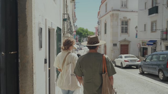 Friends walking down an old city street