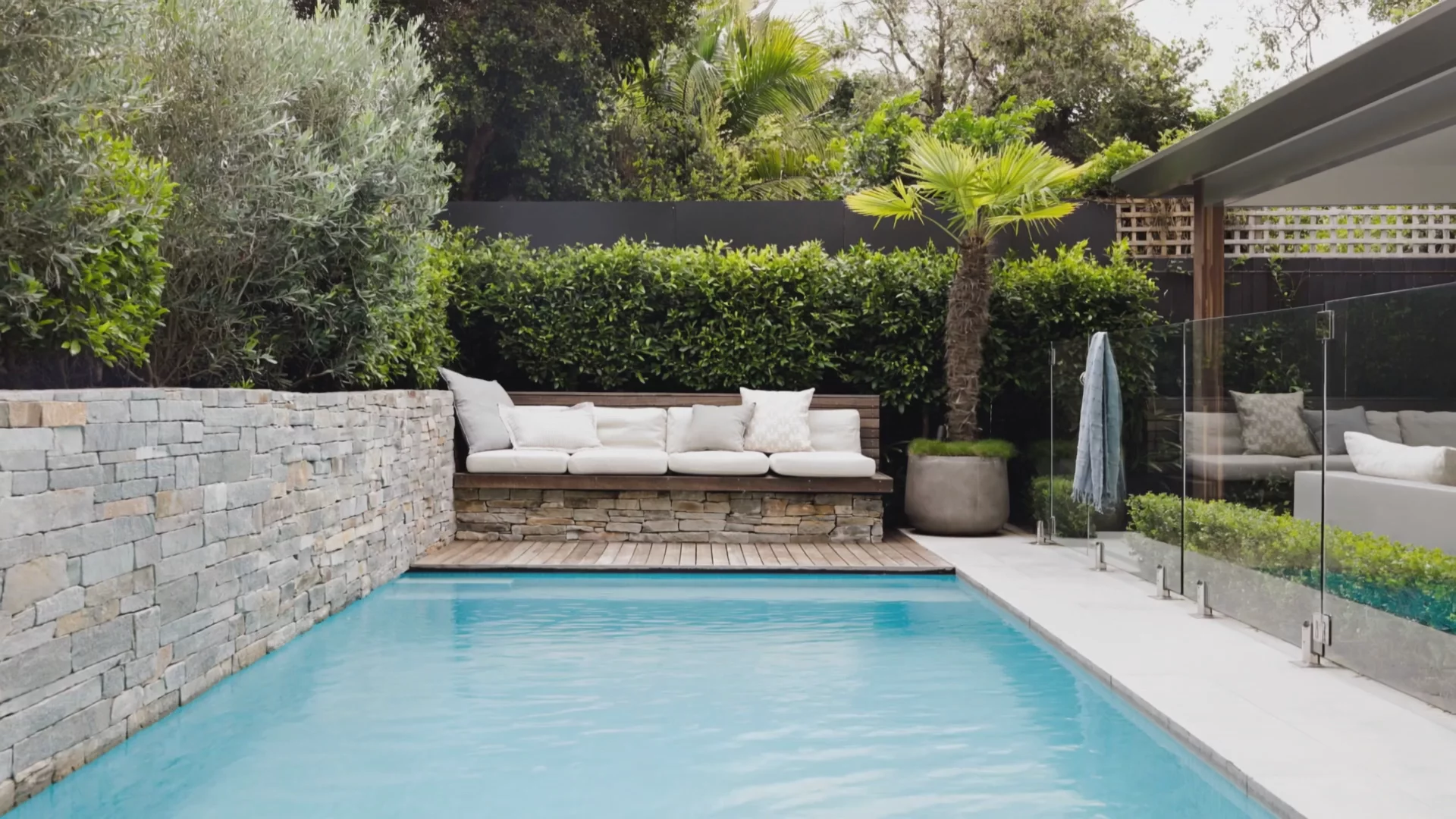 In-house construction of a pool and sandstone feature wall at a Clovelly home, Sydney