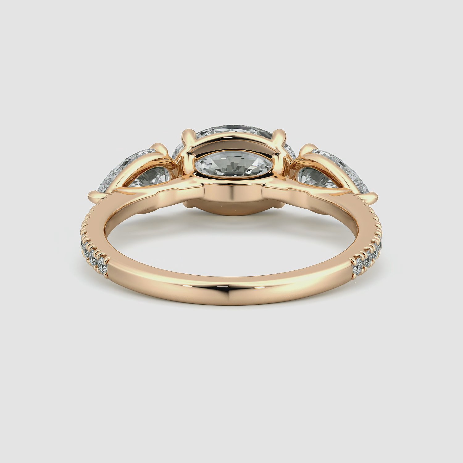 The Three Stone | Oval | 14k | Rose Gold | bandAccent: Pavé | diamondOrientation: horizontal | sideStoneCarat: 0.50ct | sideStoneShape: Pear | caratWeight: other