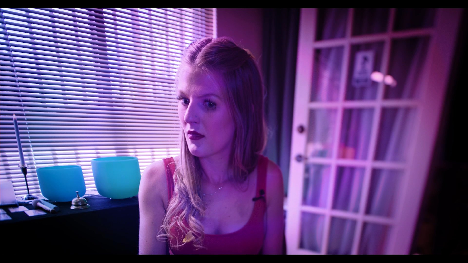 A woman consults a glowing crystal ball in a mystical setting while alternating with personal testimonies about spiritual experiences. The segment balances dramatic atmospheric imagery with direct narrative commentary.