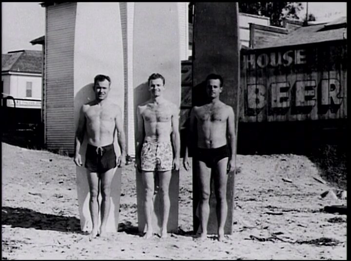 An aging surfer reflects on the history of surf culture through a series of vintage photographs and personal reminiscence. The presentation highlights the evolution of the sport from early beach gatherings to established communities.