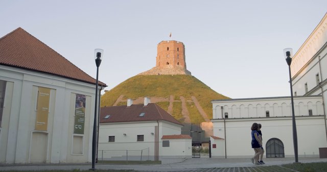 Cycling past Gedinimo Tower in Vilnius