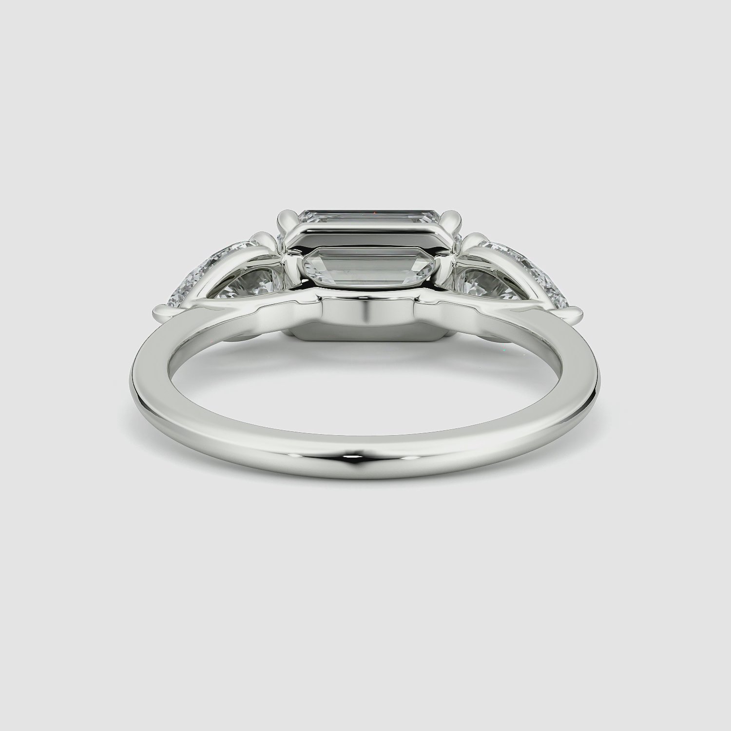 The Three Stone | Emerald | 18k | White Gold | bandAccent: Plain | diamondOrientation: horizontal | sideStoneCarat: 0.50ct | sideStoneShape: Pear | caratWeight: other
