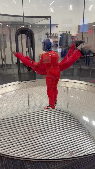 iFLY Indoor Skydiving - Queens - Flight instructor helping you fly - Party & Event Planning Near Me - Queens, New York