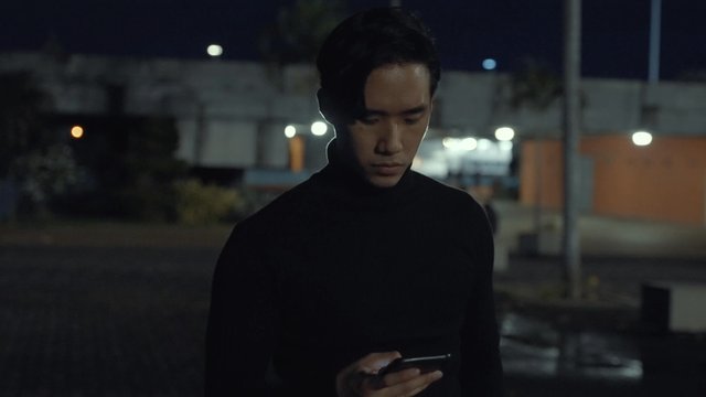 Asian man talking on a smartphone