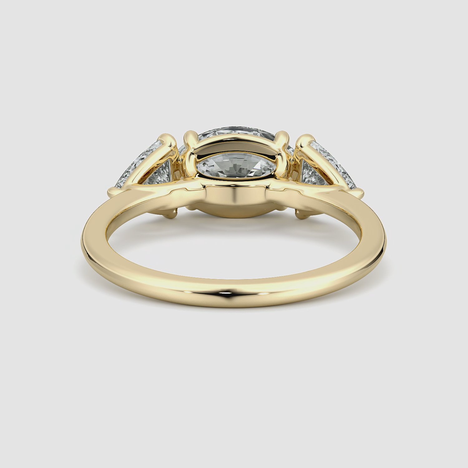 The Three Stone | Oval | 18k | Yellow Gold | bandAccent: Plain | diamondOrientation: horizontal | sideStoneCarat: 0.50ct | sideStoneShape: Trillion | caratWeight: other