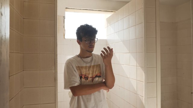 Man standing in an empty bathroom