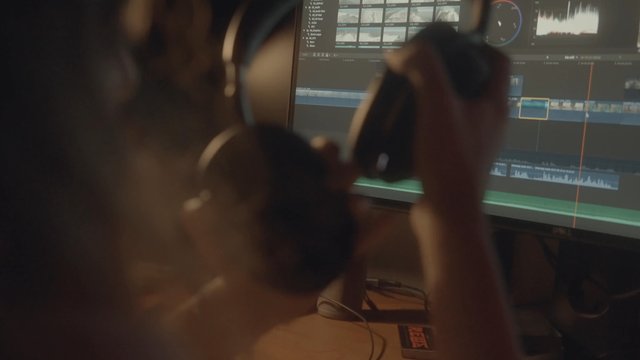 A female video editor in a production studio