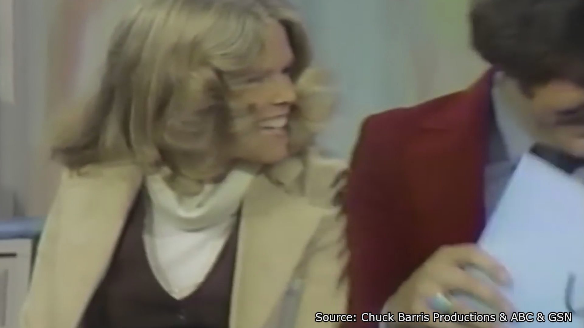 Historical footage contrasts the broadcast premiere of The Newlywed Game with the geopolitical environment of Hanoi in 1966. The sequence juxtaposes studio game show lightheartedness with aerial mapping of the Vietnamese capital.