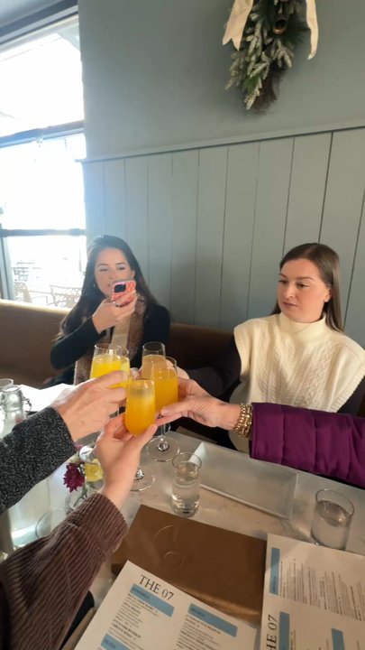 The 07 - Cheers with mango mimosas - New American Near Me - Greenville, South Carolina