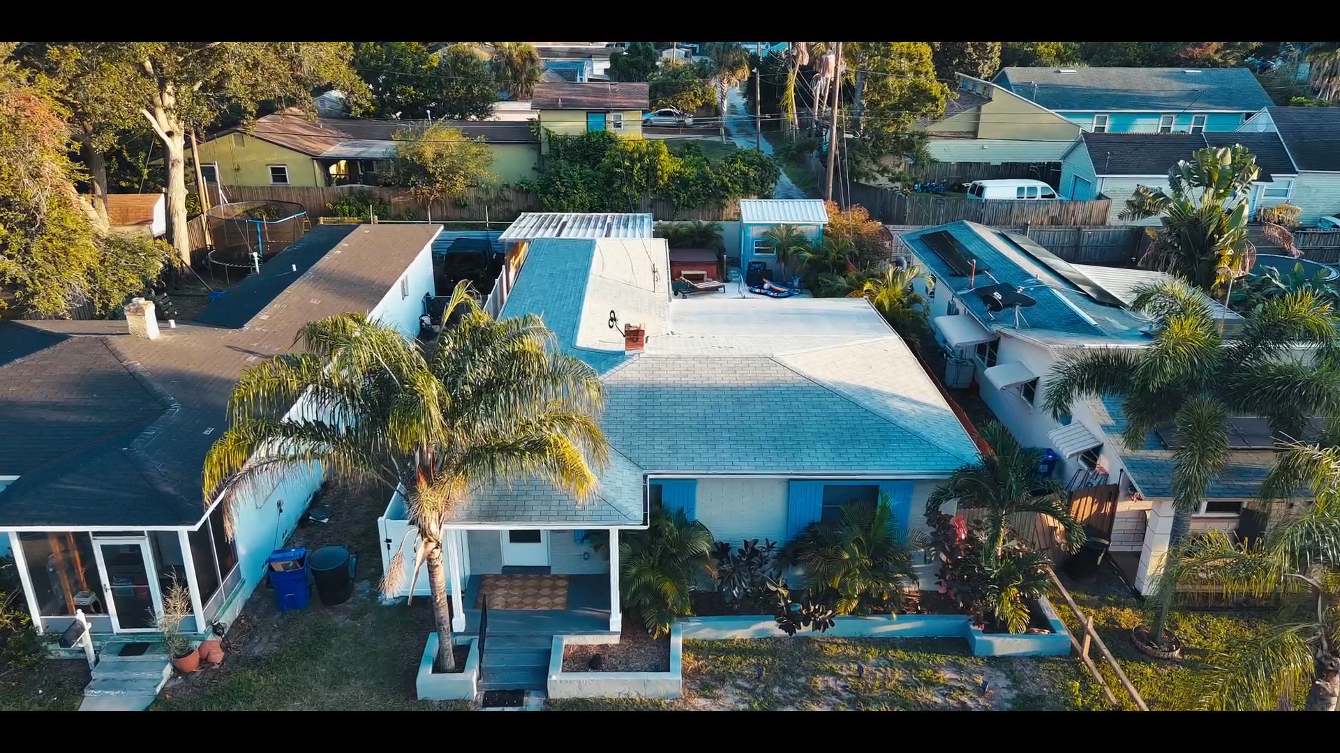 Individuals conduct professional phone conversations regarding residential property inquiries while visuals transition from a home office setting to an aerial view of a suburban home.