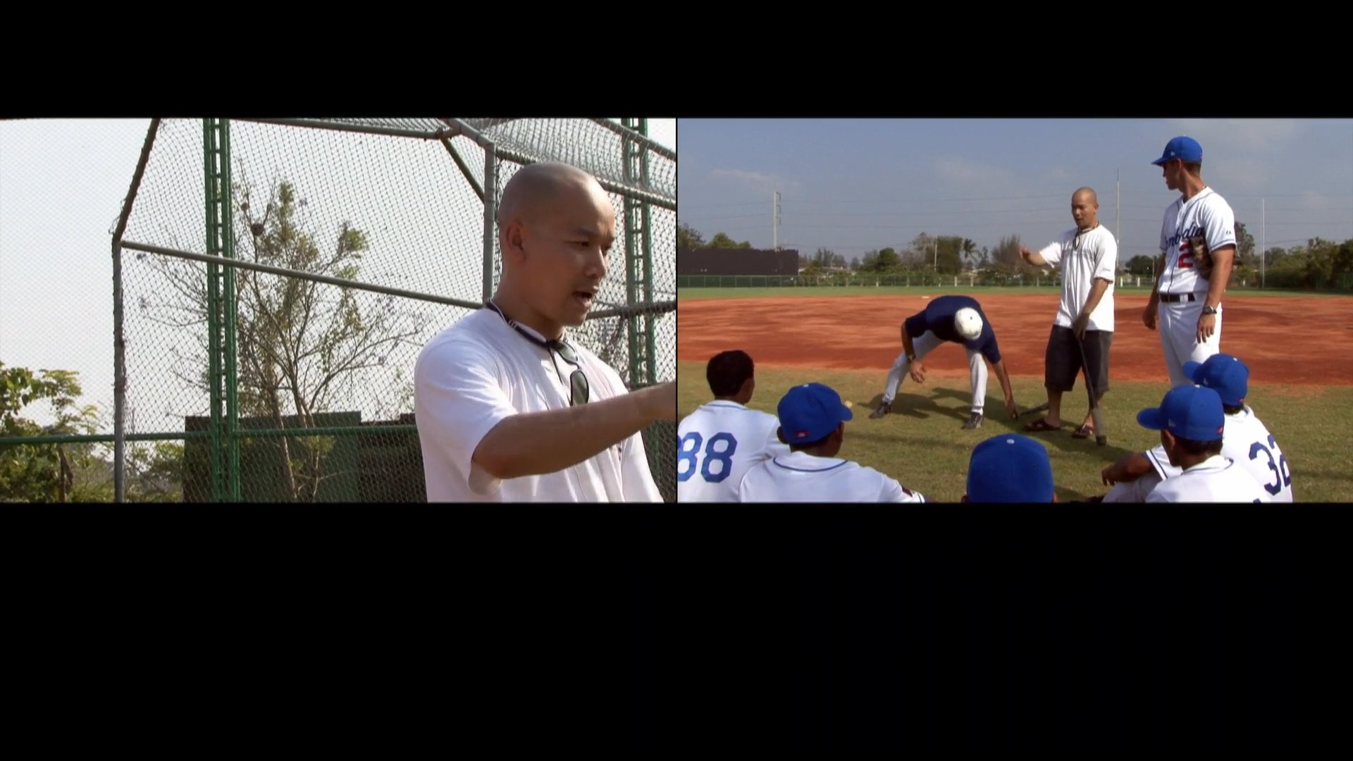 A baseball coach instructs a group of players on proper batting techniques during an outdoor practice session on a baseball field.