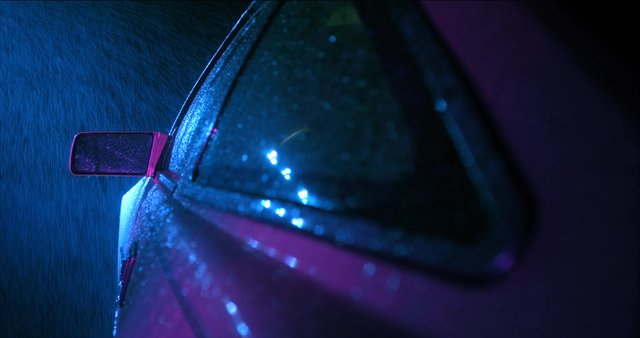 Close-up shot of a car in the rain