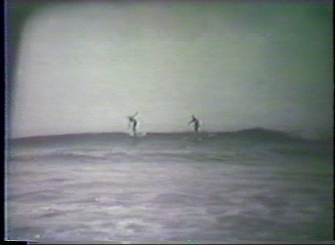 Two surfers navigate breaking waves in the ocean, demonstrating balancing techniques across a series of riding sequences.