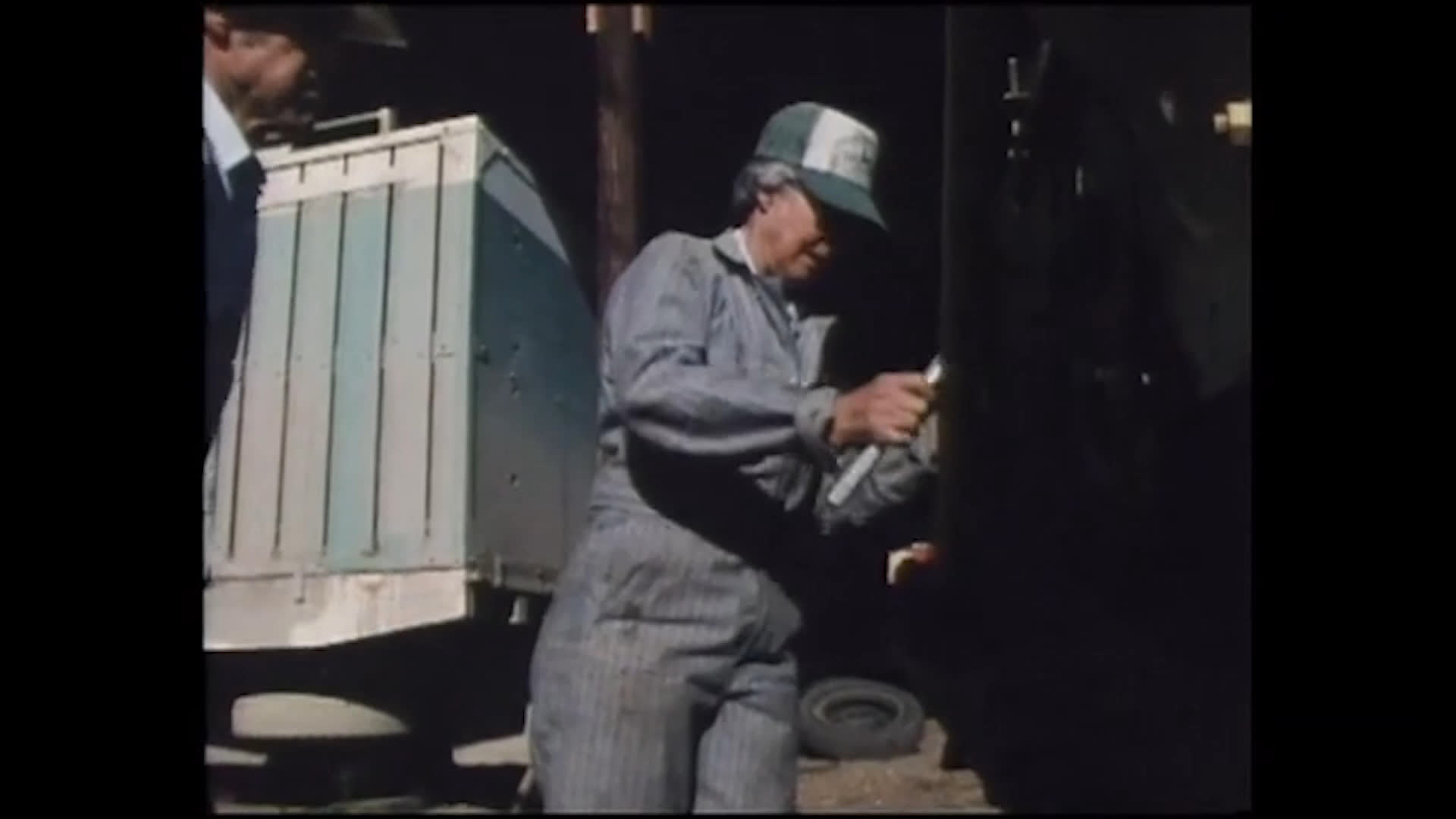 At home, family members prepare food before two ranch hands work together beside a livestock trailer. The scenes capture everyday life on a Nevada family ranch, which the speaker calls the best life there is.